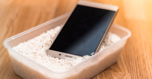 Android smartphone with water damage sitting in tub of rice