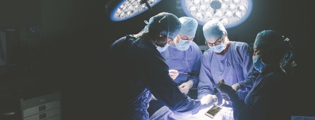 surgeons in an operating room fixing a broken phone screen