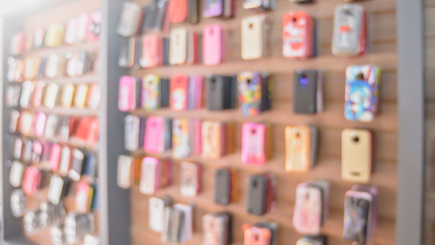 Blurry images of a sales wall full of phone cases and other accessories